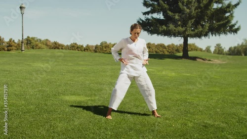 Fitness woman training exercise outdoor in summer park. Sport coach practicing stretch exercise and yoga on outdoor workout. Yoga woman practicing asana