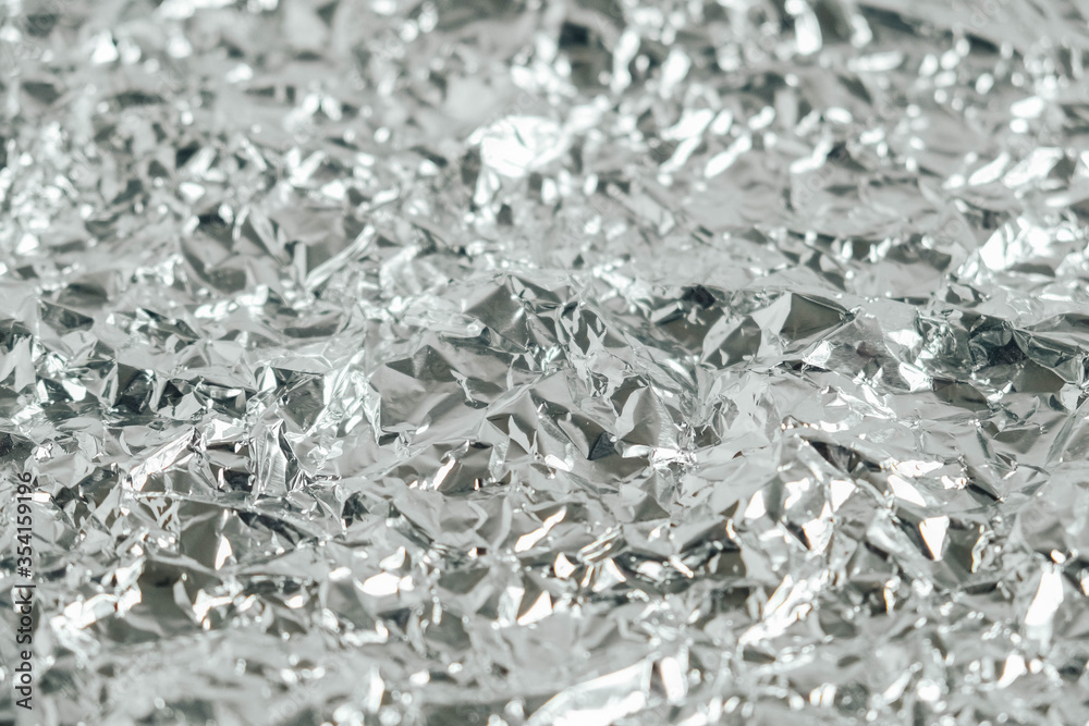 Surface texture of crumpled aluminum silver foil. Copy, empty space for text Surface texture of crumpled aluminum silver foil. Copy, empty space for text