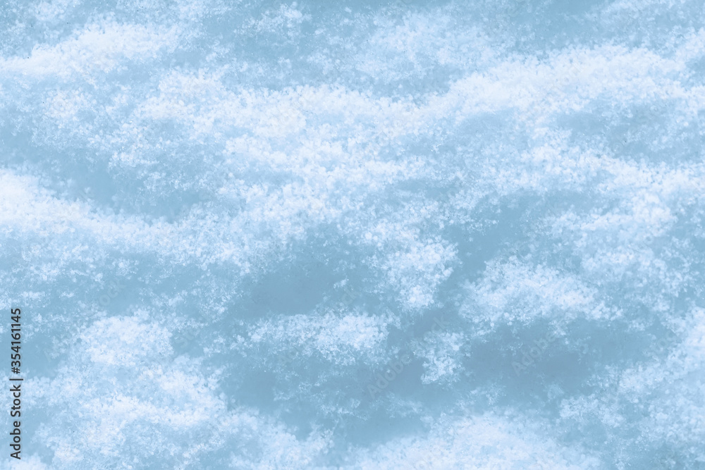 Snow surface texture background. Crystals and snowflakes. Winter natural background.