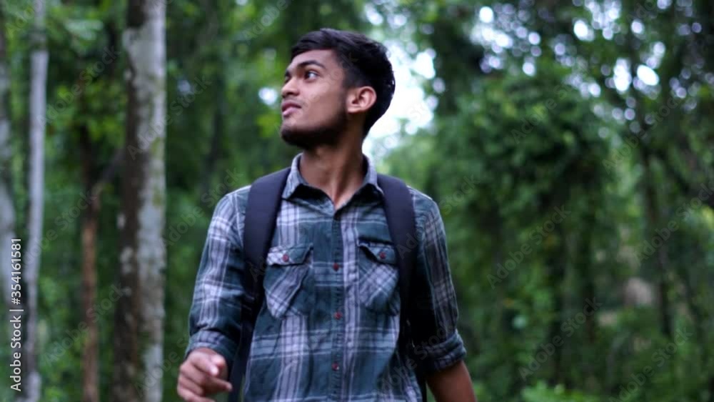 young man tourist walking through the woods with backpack concept travel tourism young man tourist walking through the woods with backpack concept travel tourism