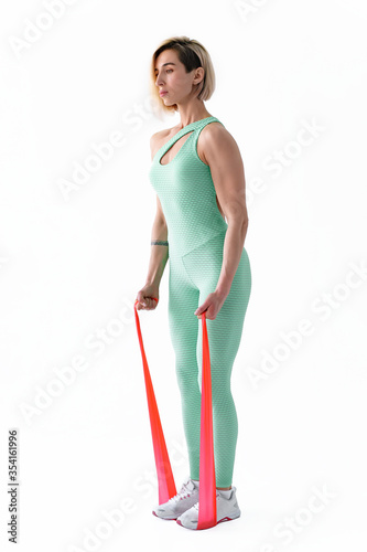 Woman exercising fitness resistance bands in studio silhouette isolated on white background. photo