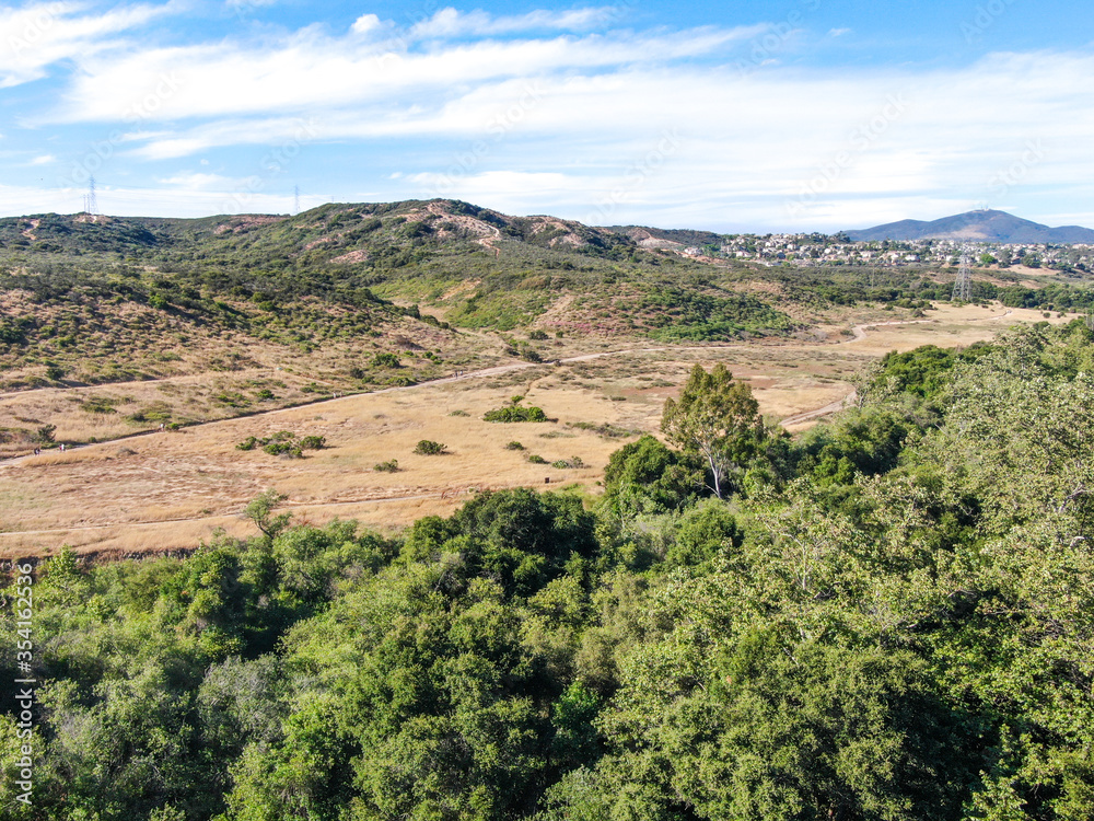 Aerial view of Los Penasquitos Canyon Preserve during dry season. Urban park with mountain, forest and trails in San Diego, California. USA