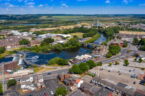 Aerial photo of the village centre of Castleford in Wakefield, West Yorkshire, England showing the main street along side the River Aire on a bright sunny summers day photo