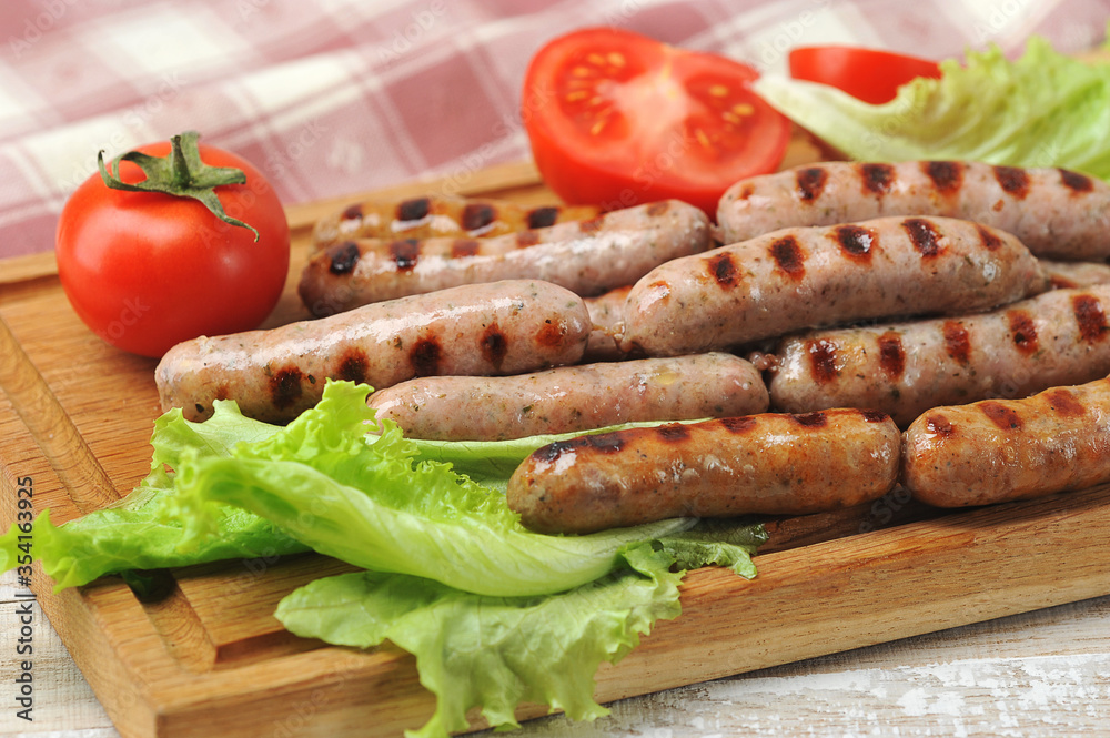 grilled smoked sausages, lettuce leaves, tomatoes grilled smoked sausages, lettuce leaves, tomatoes