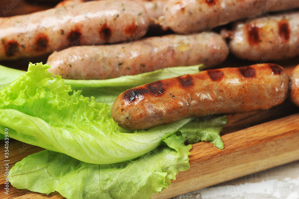 grilled smoked sausages, lettuce leaves grilled smoked sausages, lettuce leaves