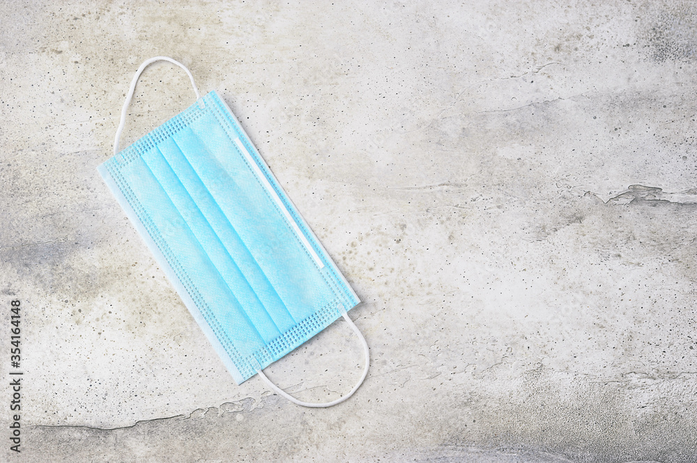 blue protective mask on a grey concrete