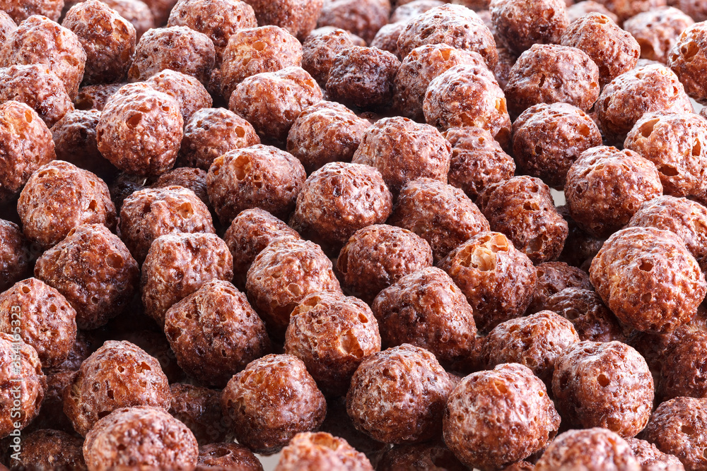 Chocolate corn balls isolated on white background. Chocolate balls dry breakfast scattered on a white background. Space for text. Also known as Chocolate flakes. Full depth of field. Chocolate corn balls isolated on white background. Chocolate balls dry breakfast scattered on a white background. Space for text. Also known as Chocolate flakes. Full depth of field.