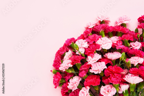 Pink carnation flowers bouquet on pink background. Mother s day  Valentines Day  Birthday celebration concept. Greeting card. Copy space