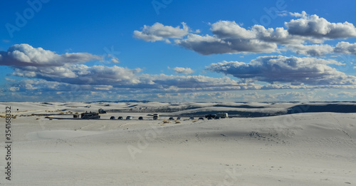 USA, NEW MEXICO - NOVEMBER 23, 2019: Desert landscape of gypsum dunes, tourist cars among sand dunes in White Sands National Monument in New Mexico, USA