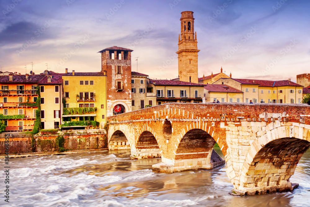 Famous Verona landmark. Ponte di Pietra over Adige river during sunset in Verona, Italy
