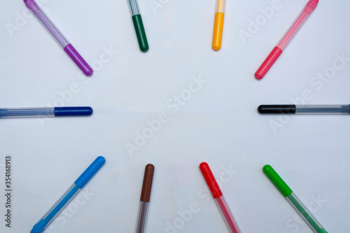 Multi-colored felt-tip pens on a white background. Place for text. Markers - a subject for drawing.