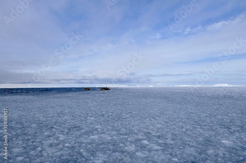 Rubber boats in ice floes at edge of pack ice in antarctic ocean, Antarctica
