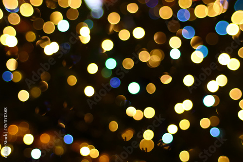 Blurred defocused background with brilliant golden lights. Christmas abstract backdrop