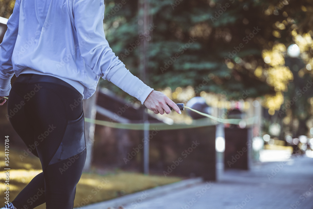 woman skipping with jump rope outdoors