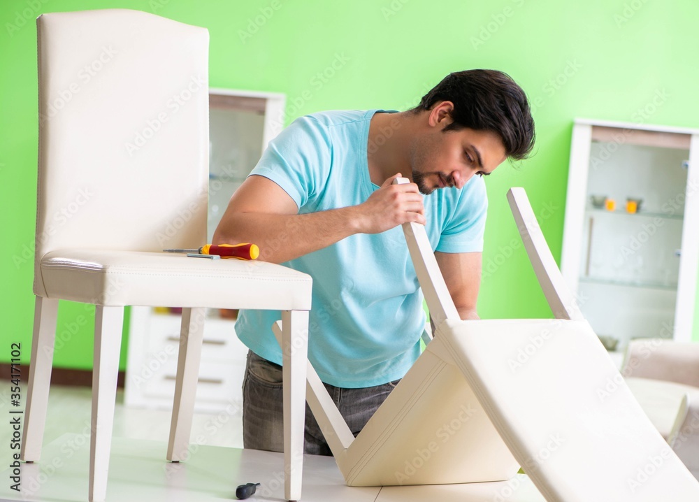 Man repairing furniture at home Man repairing furniture at home