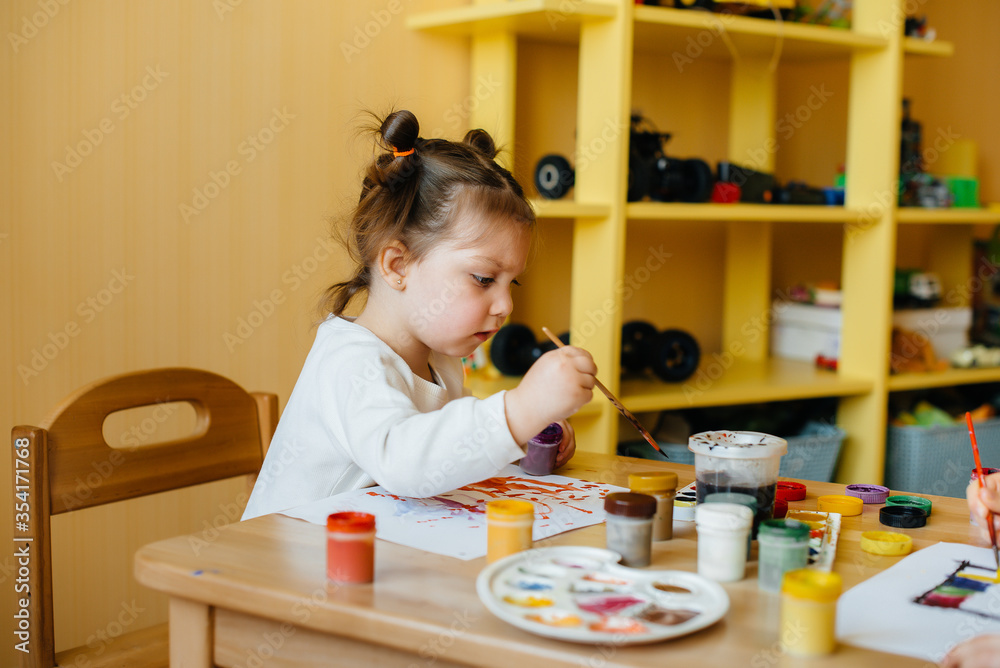 A cute little girl is playing and painting in her room. Recreation and entertainment A cute little girl is playing and painting in her room. Recreation and entertainment