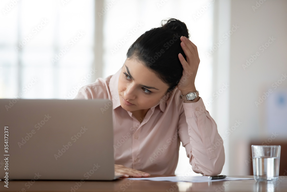 Head shot unhappy young female hindu employee feeling stressed at workplace. Tired unmotivated indian businesswoman stuck with hard task, looking away. Upset exhausted woman need rest in office. Head shot unhappy young female hindu employee feeling stressed at workplace. Tired unmotivated indian businesswoman stuck with hard task, looking away. Upset exhausted woman need rest in office.