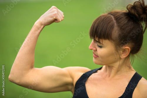 beautiful adult woman in sportswear in the summer in the park