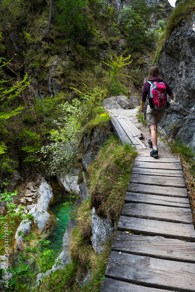 Young Girl Hiking Beneath Clear And Wild Mountain River In Green Canyon In Ötschergräben In Austria