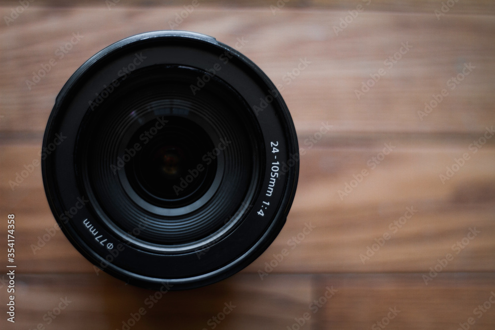 camera lens on a wooden background