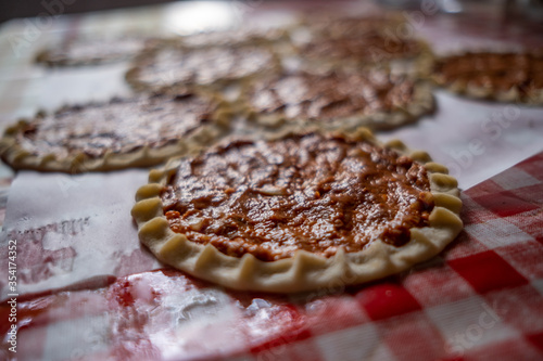 Top view of homemade pide, turkish flatbread with ground meat, mini pita breads or mini turkish pizzas