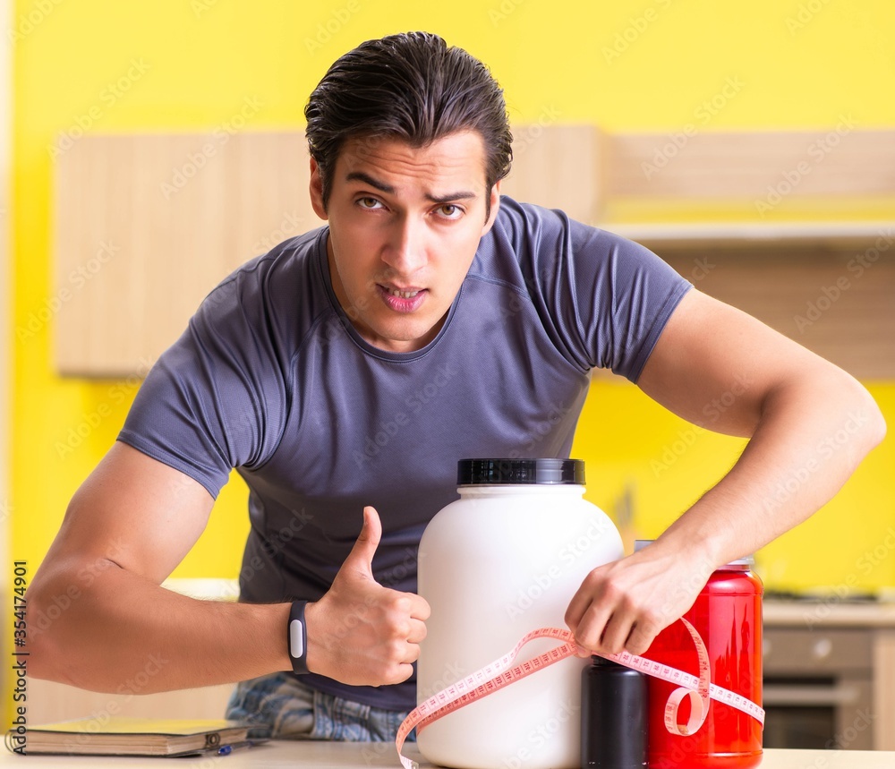 Young man blogging about food supplements Young man blogging about food supplements