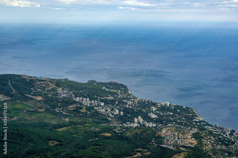 Summer aerial view on the city by the sea coast with horizont