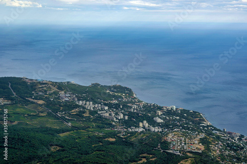 Summer aerial view on the city by the sea coast with horizont