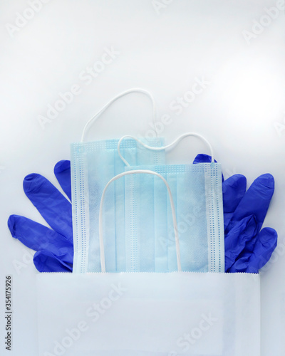 COVID-19. Coronavirus. Coronavirus infection. Two disposable medical masks and a pair of latex gloves. Medical kit of necessary disposable items. Medical protection of the face and hands.