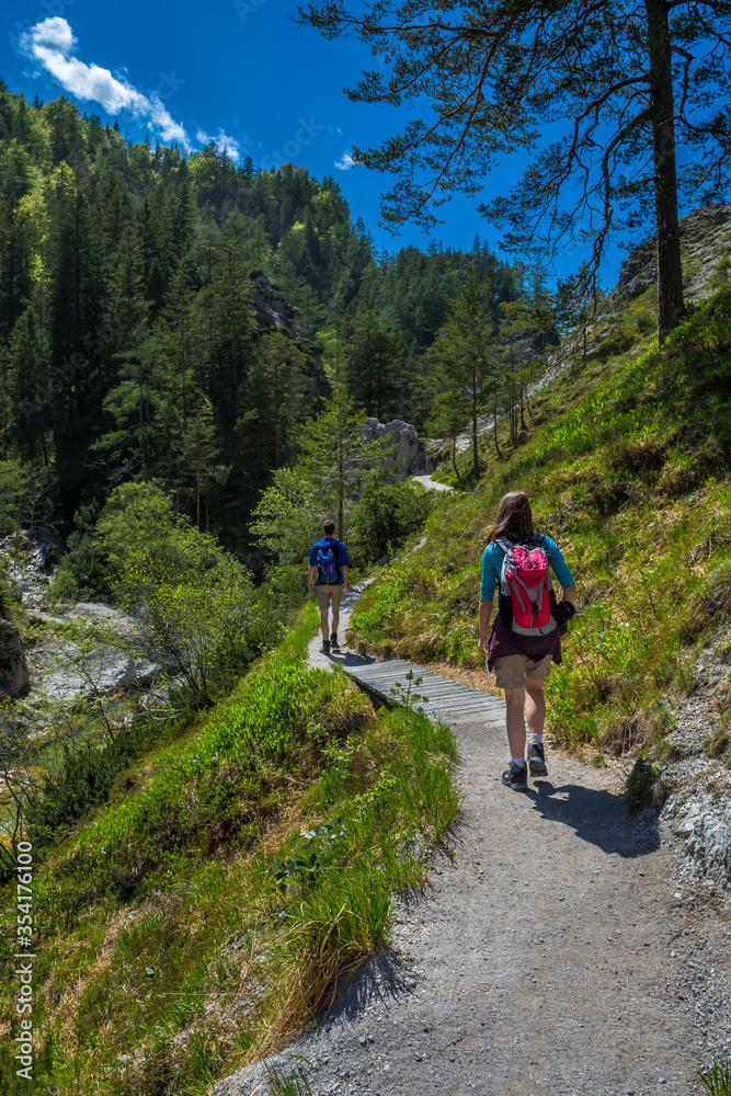 Young People Walk On Mountain Hiking Trail In Ötschergräben In Austria
