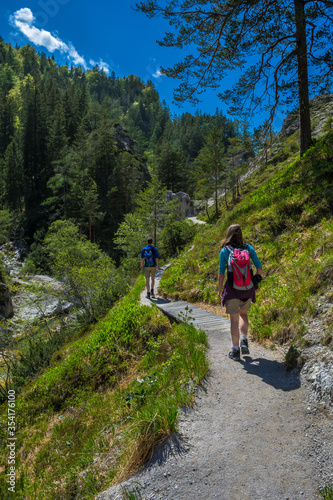 Young People Walk On Mountain Hiking Trail In Ötschergräben In Austria