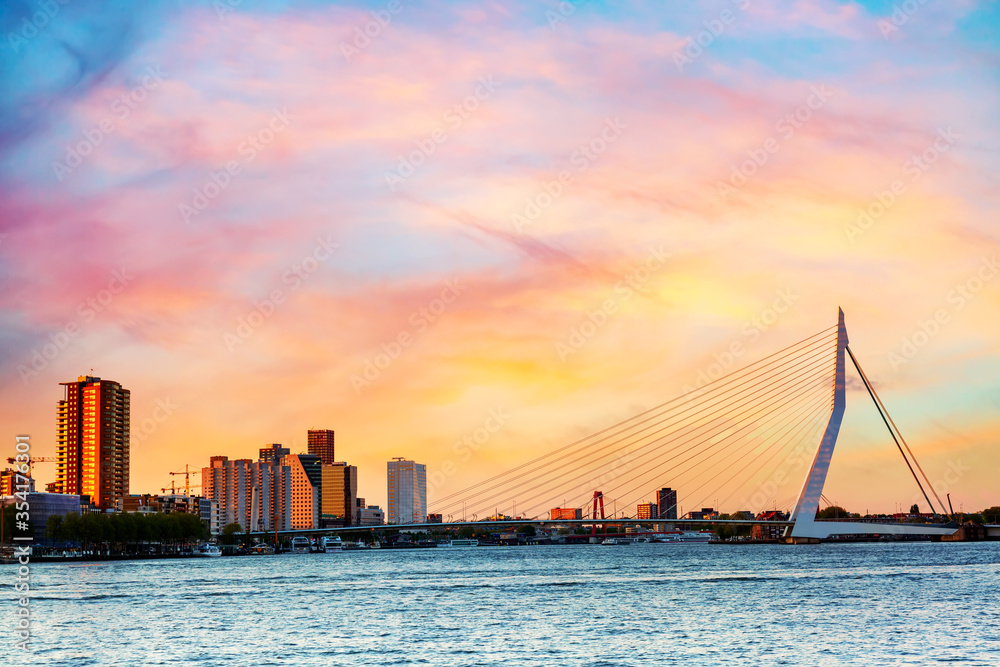 Rotterdam panorama. Erasmus bridge over the river Meuse with skyscrapers in Rotterdam, South Holland, Netherlands during twilight sunset.