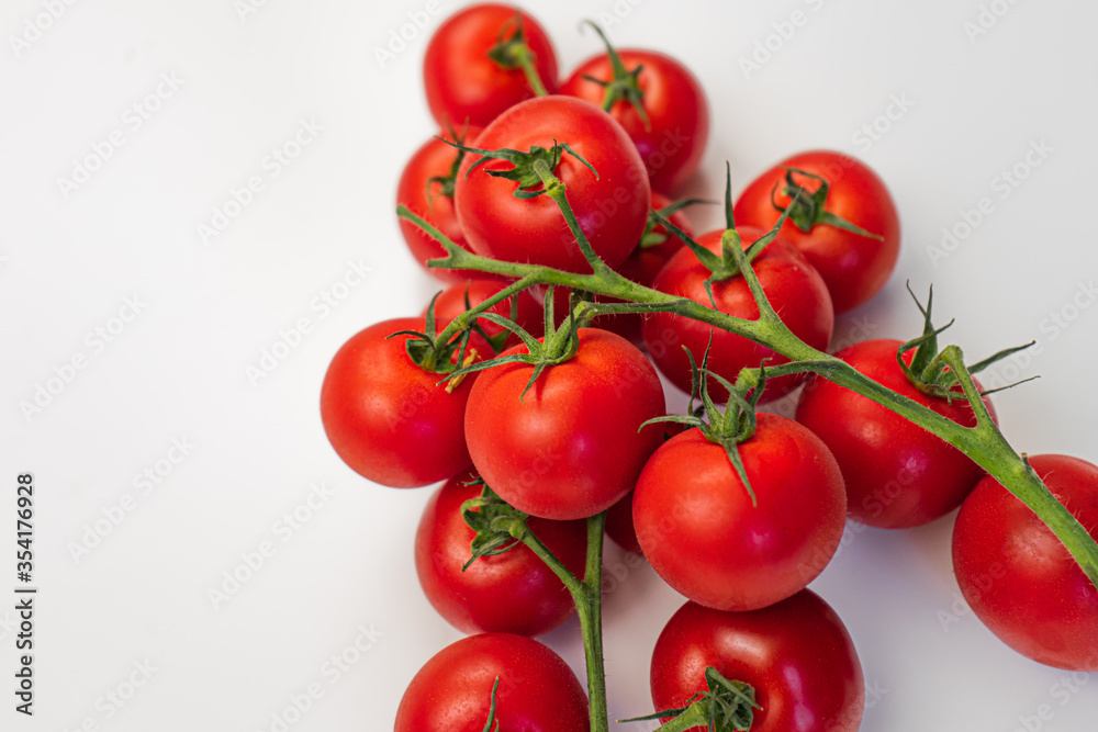Cherry tomatoes on a branch close-up white background Cherry tomatoes on a branch close-up white background