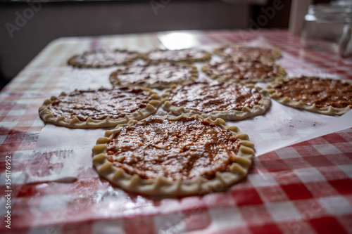 Top view of homemade pide, turkish flatbread with ground meat, mini pita breads or mini turkish pizzas