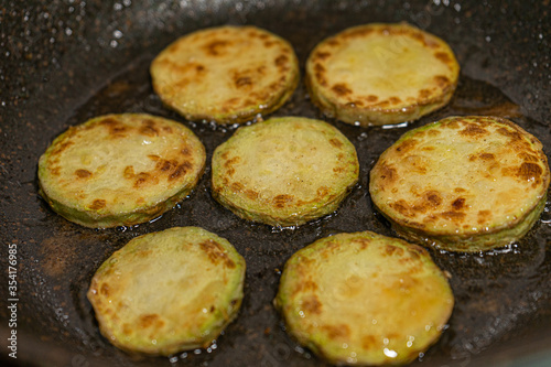 Zucchini fried in vegetable oil in a pan