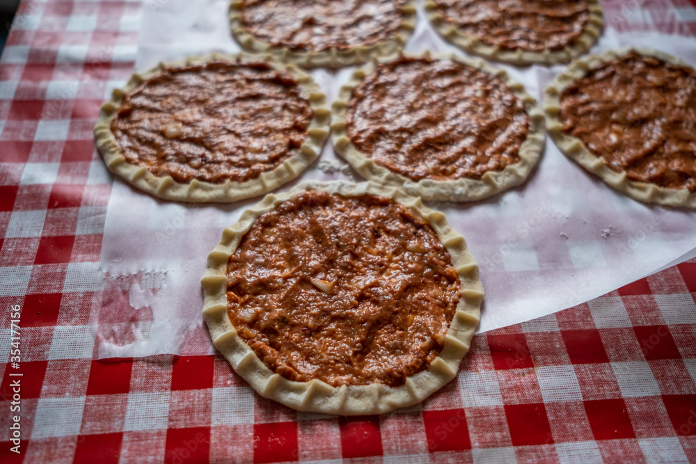 Top view of homemade pide, turkish flatbread with ground meat, mini pita breads or mini turkish pizzas