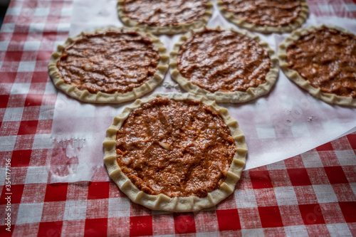 Top view of homemade pide, turkish flatbread with ground meat, mini pita breads or mini turkish pizzas