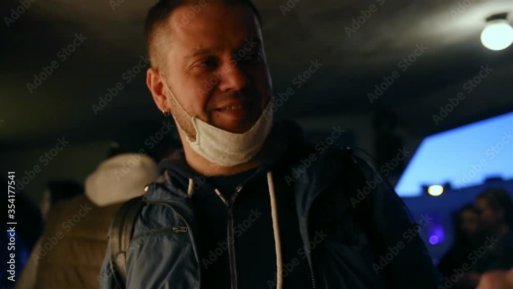 A man took off a medical mask in a crowded public place, scringe, squints and waves his hand because of a strong or unpleasant smell. Real time, sunset, contains people, feelings, emotions A man took off a medical mask in a crowded public place, scringe, squints and waves his hand because of a strong or unpleasant smell. Real time, sunset, contains people, feelings, emotions