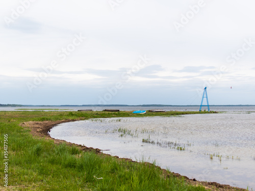 a lone boat in the lake in cloudy weather.  summer holiday