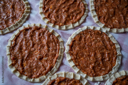 Top view of homemade pide, turkish flatbread with ground meat, mini pita breads or mini turkish pizzas