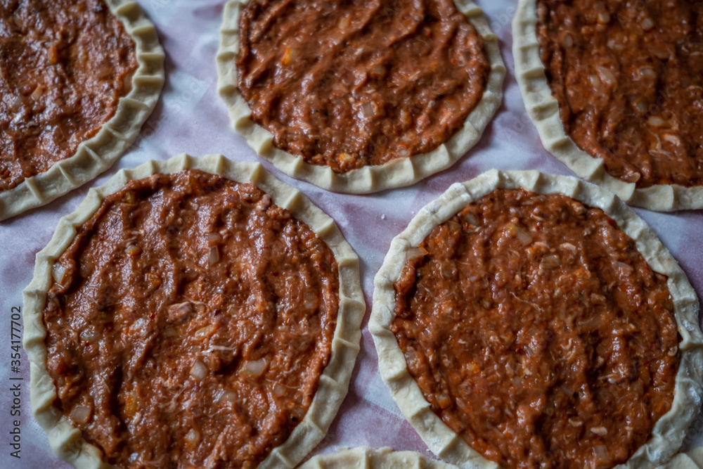 Top view of homemade pide, turkish flatbread with ground meat, mini pita breads or mini turkish pizzas