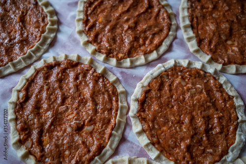 Top view of homemade pide, turkish flatbread with ground meat, mini pita breads or mini turkish pizzas