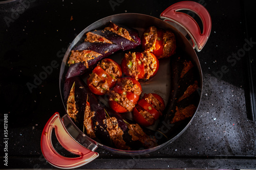 Top view of turkish eggplant kebab in pot or cooker with tomatos and minced meat, ready to cook, patlican kebab