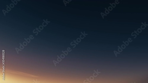 Night to day transition timelapse video. Sparkle sun moves across blue cloudy sky. Dynamic light rays, lens flare effect. Sunrise and sunset. Starry evening. Nature concept animation. Seamless 4K clip
