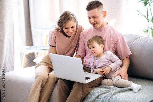 Video meeting with family. Mom dad and their little son communicate via video conference with grandparents