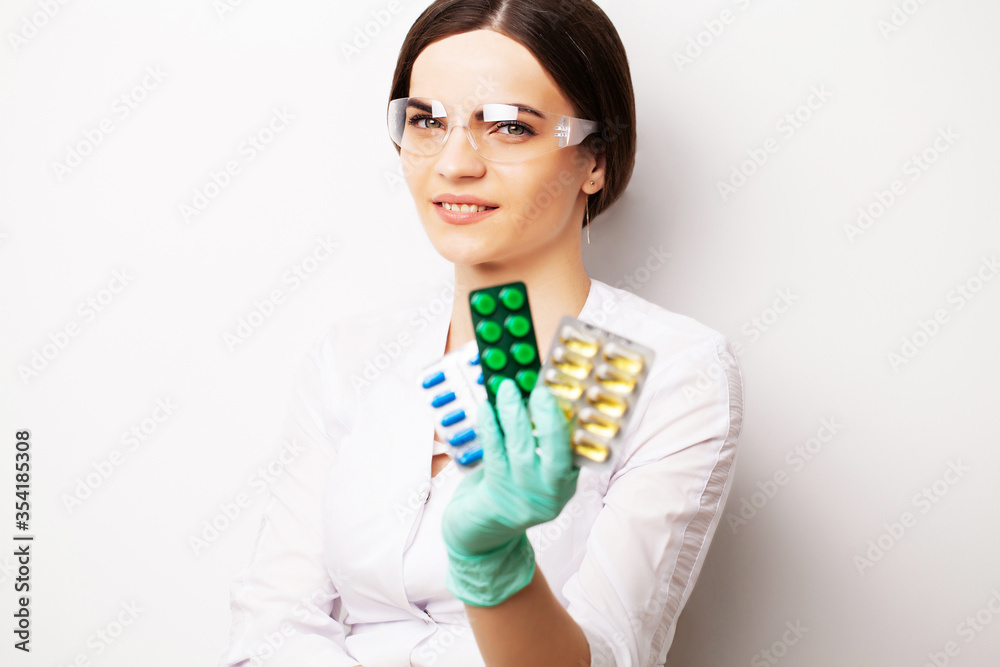 Sexual health, a doctor in a white coat holding a pill for a healthy sex life of men Sexual health, a doctor in a white coat holding a pill for a healthy sex life of men