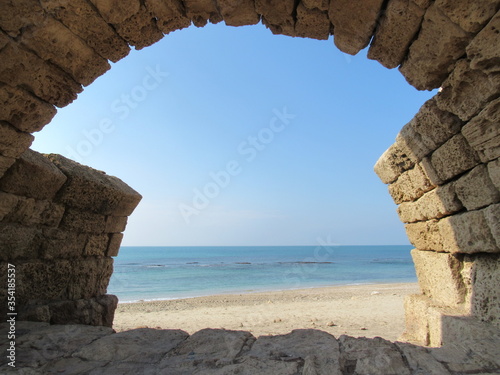 View of Mediterranean Sea through the arches of the ancient Roman aquaducts in Caesarea, Israel photo