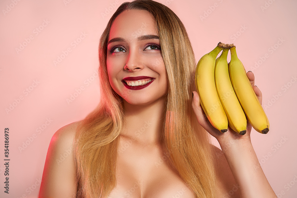 Beautiful girl with bananas in studio, isolated. Food, fashion, healthcare, cosmetology concept, space for text Beautiful girl with bananas in studio, isolated. Food, fashion, healthcare, cosmetology concept, space for text