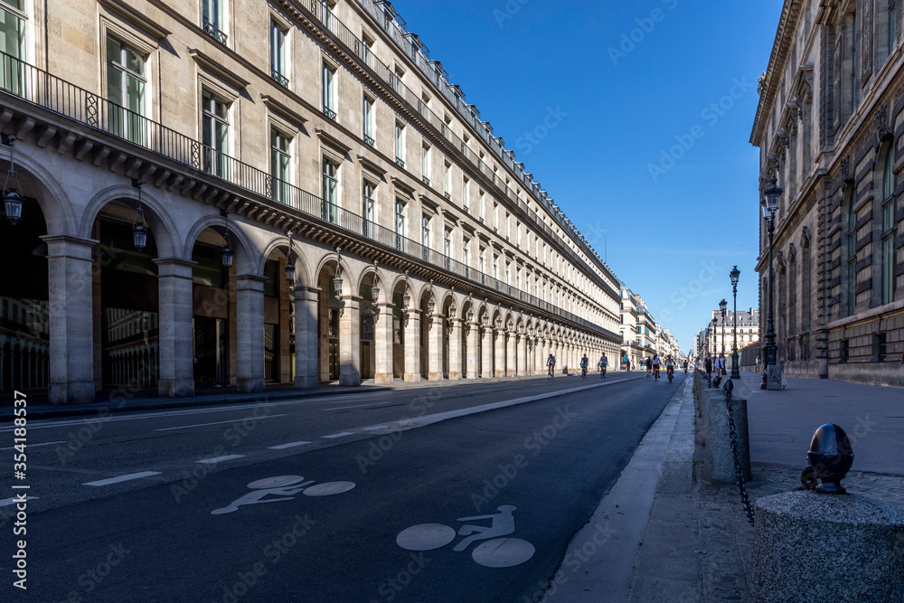 Paris, France - May 29, 2020: Cyclist drives on empty street (Rue de Rivoli) during the COVID-19-Pandemic lockdown in Paris
