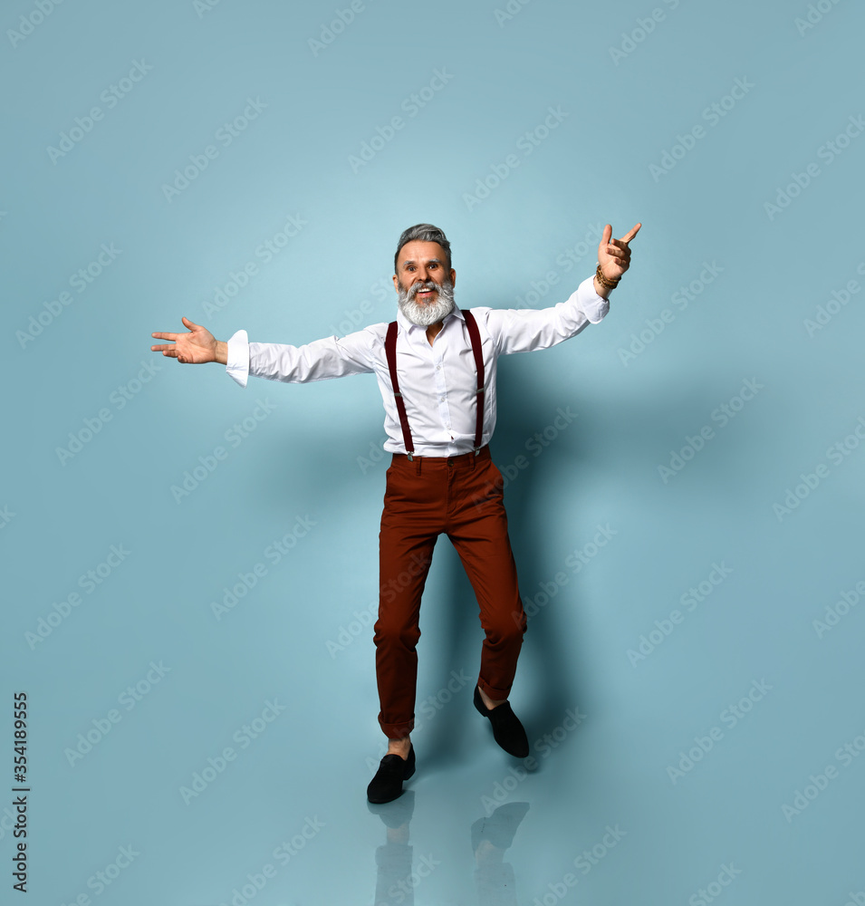 Handsome portrait of a senior man - a young and stylish man in the sixties, opened his arms, ready to hug you, concepts about lifestyle Handsome portrait of a senior man - a young and stylish man in the sixties, opened his arms, ready to hug you, concepts about lifestyle